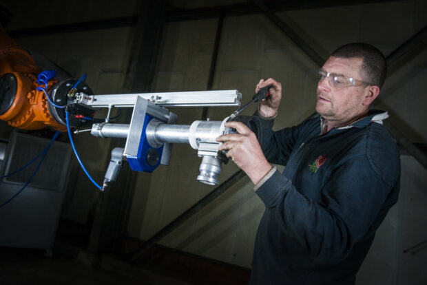 An operator adjusts one of the tools