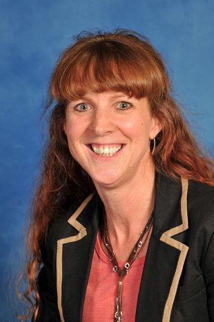 Alison Stafford smiling into the camera wearing a black jacket