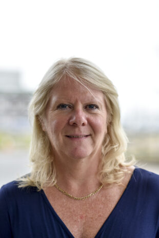 Dorothy Gradden smiling for the camera with the Sellafield site in the background