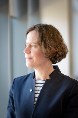 A portrait picture of Rebecca Weston wearing a navy blue suit