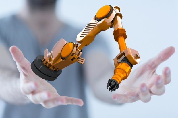 Human hands holding a robot