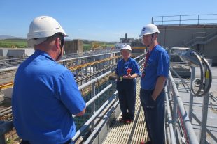 Martin Chown talking to employees standing on the gantry of FGMSP