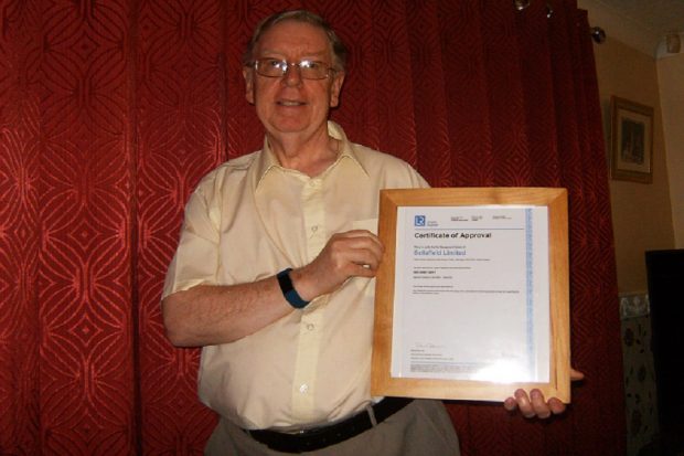 An image of Stephen Scott holding up a certificate