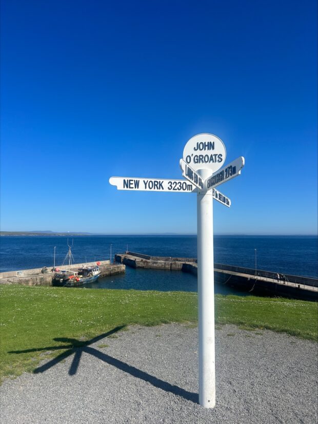 John O'Groats signpost with sea view in the background