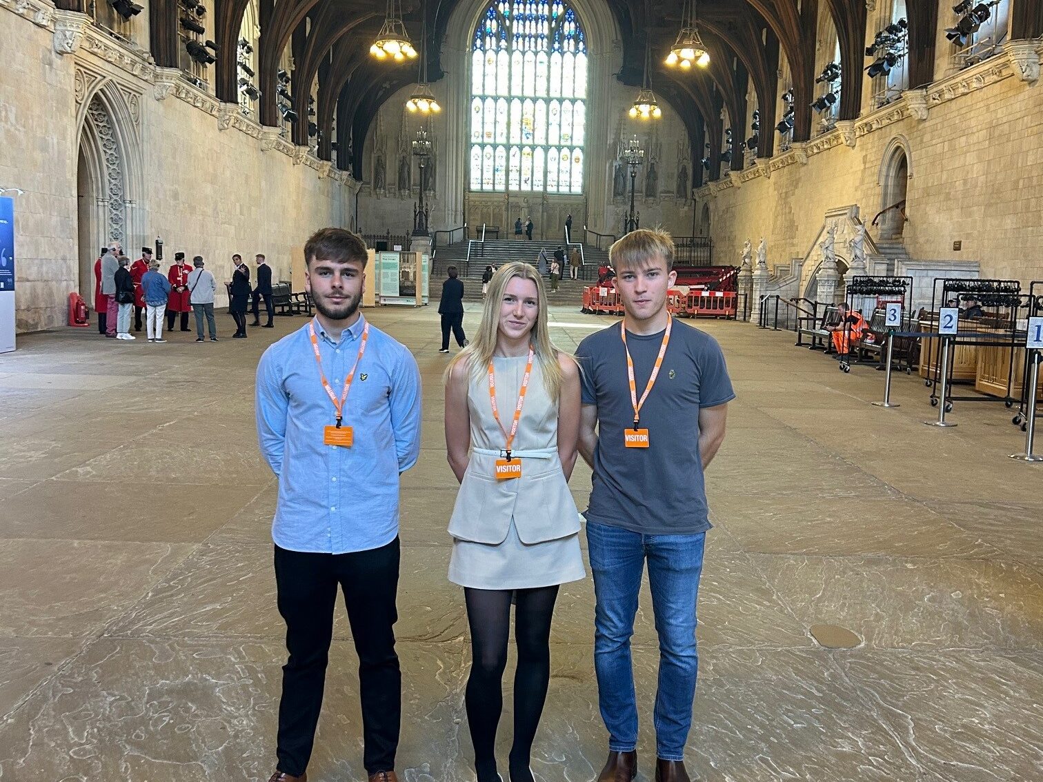 Three apprentices stood inside the Houses of Parliament.